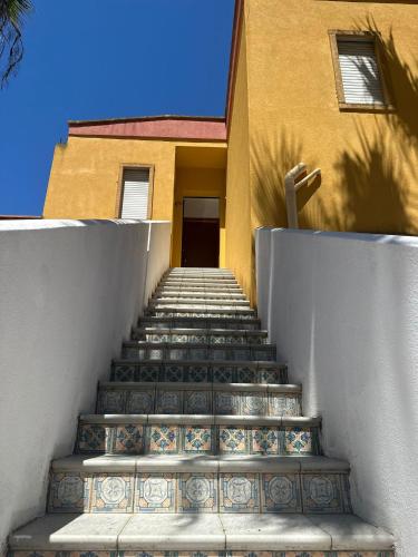 a set of stairs leading to a building with a door at Cala San Giorgio Residence in Sciacca