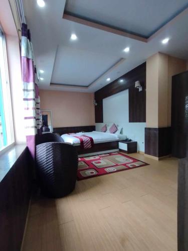 a bedroom with a bed and a rug on the floor at Hotel Gorkha Palace Pvt. Ltd in Gorkhā