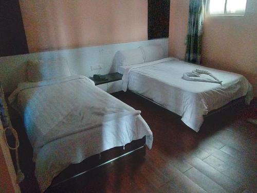 two beds in a hospital room withermottermott at Hotel Gorkha Palace Pvt. Ltd in Gorkhā