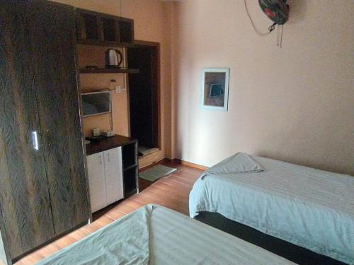a hotel room with two beds and a kitchen at Hotel Gorkha Palace Pvt. Ltd in Gorkhā