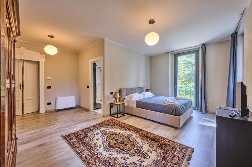 a bedroom with a bed and a large window at Villa Adriana in Lierna