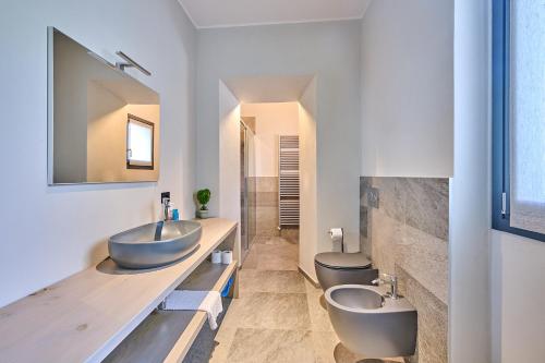 a bathroom with two sinks and two toilets at Villa Adriana in Lierna
