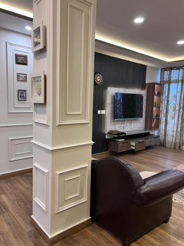 a living room with a couch and a television at Blue sky Apartment in Nathia Gali