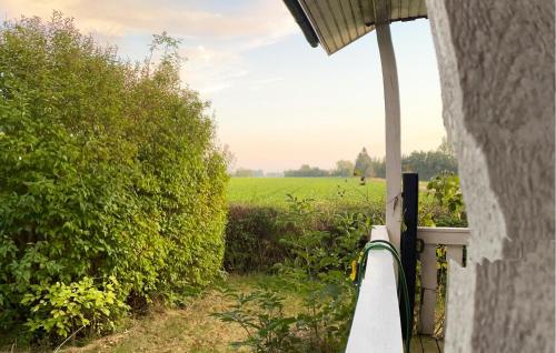 a view of a field from the porch of a house at 1 Bedroom Lovely Home In Nørre Alslev in Nørre Alslev