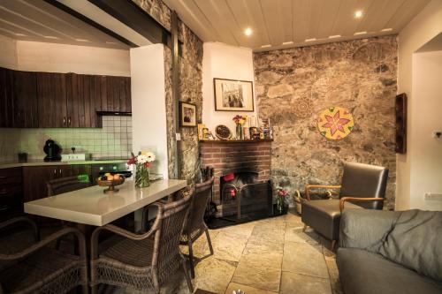 a kitchen and a living room with a table at Anastou's Traditional House in Kalopanayiotis