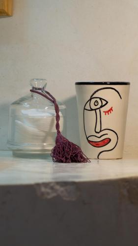 a coffee cup and a candle on a table at Riad Al Manara in Essaouira