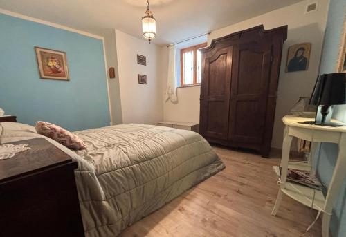 a bedroom with a bed and a wooden door at Linda's house in Monforte dʼAlba