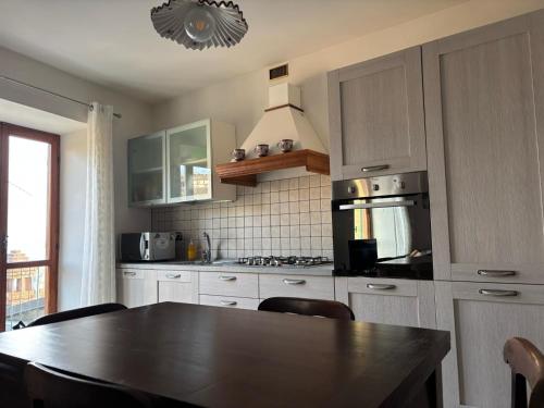 a kitchen with a table and a stove top oven at Linda's house in Monforte dʼAlba
