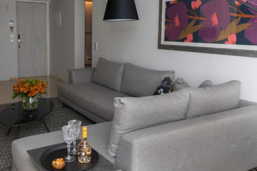 a living room with a couch and a table at Brasil Suites Boutique Hotel in Athens