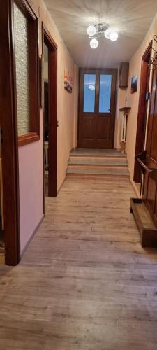 an empty hallway with wooden floors and doors at Linda's house in Monforte dʼAlba