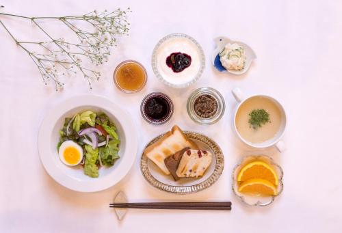 a white table with plates of food and bowls of food at Hotel Great Morning in Fukuoka