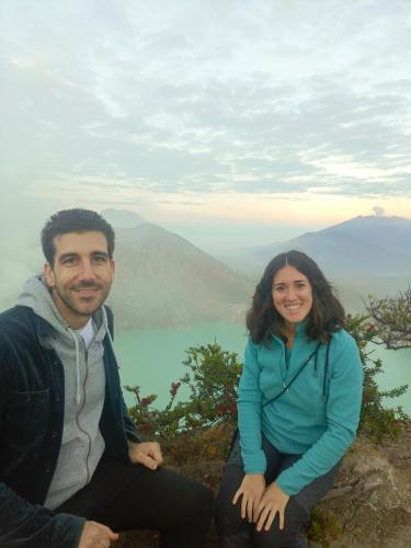 a man and a woman sitting on top of a mountain at Nio Homestay and Tour in Licin