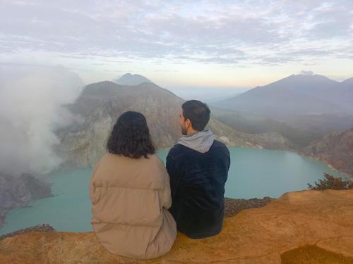 a man and woman sitting on top of a mountain at Nio Homestay and Tour in Licin