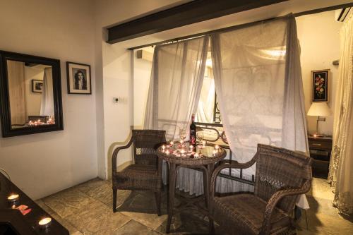a room with a table and chairs and a window at Anastou's Traditional House in Kalopanayiotis