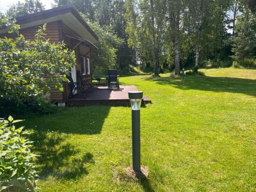 a parking meter in the grass in front of a cabin at Katase Tiny House in Katase