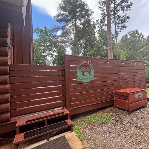 a large wooden fence with a sign on it at Mountain Ridge Retreat Blue Ridge in Blue Ridge