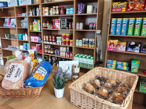 a store with two baskets of food on a counter at Polborder Holidays Looe Country Park in Looe