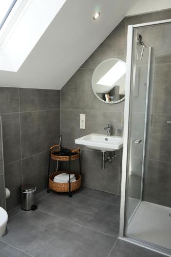 a bathroom with a sink and a shower at Hain Estate Appartements in Piesport