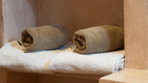 a couple of towels sitting on top of a shelf at Riad Al Manara in Essaouira