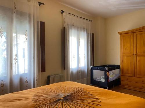 a bedroom with a bed with a large fan on it at Casa Rural Almécija in Illar