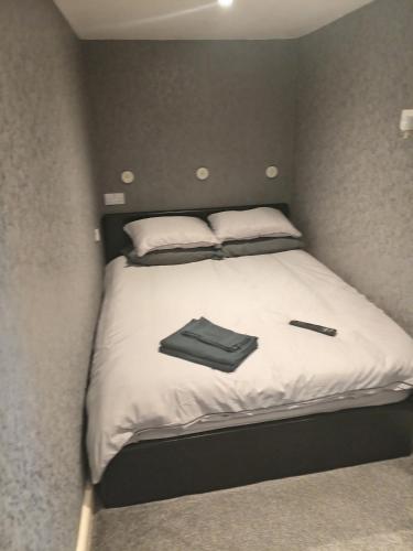 a small bed with two pillows and a wallet on it at Alocin cottage in Melmerby