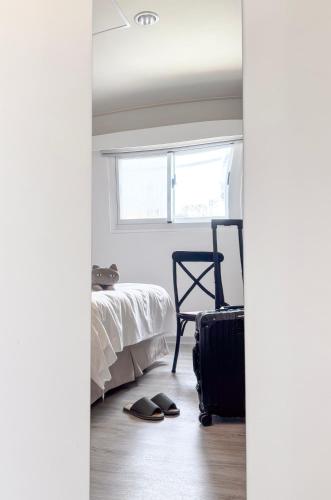 Postel nebo postele na pokoji v ubytování 信然文旅-New 凝萃海安 pet-friendly hotel 寵物事先預訂