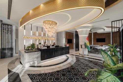 a lobby of an atlas hotel with a large chandelier at Ankawa Holiday Hotel in Erbil