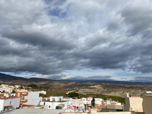a view of a city under a cloudy sky at Casa Rural Almécija in Illar