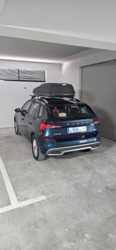 a car is parked in a parking garage at M&A apartman in Trebinje