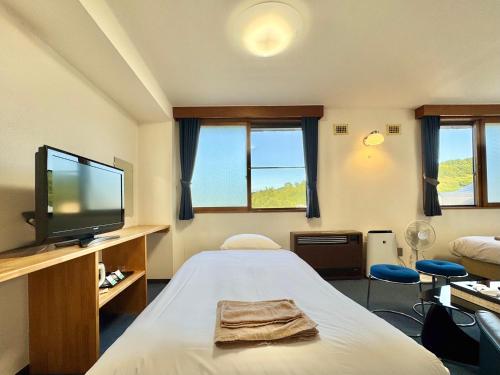 a hospital room with a bed and a flat screen tv at Hotel Sol at Lake Toya in Lake Toya