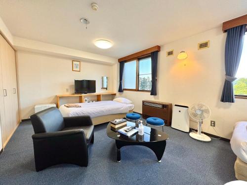 a hotel room with a bed and a table at Hotel Sol at Lake Toya in Lake Toya