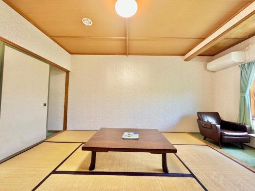 a living room with a table and a chair at Hotel Sol at Lake Toya in Lake Toya