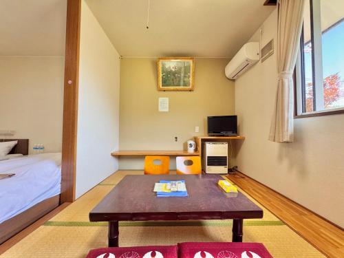a small room with a bed and a table in it at Hotel Sol at Lake Toya in Lake Toya