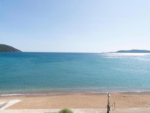 a beach with the ocean and a light on it at Villa in Finikounta near Sandy Beach in Finikounta