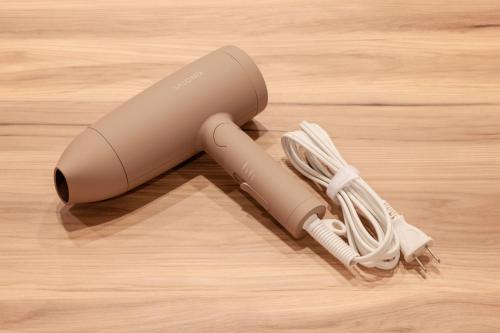 a remote control sitting on top of a wooden floor at LUX by Hotel BAL in Fukuoka
