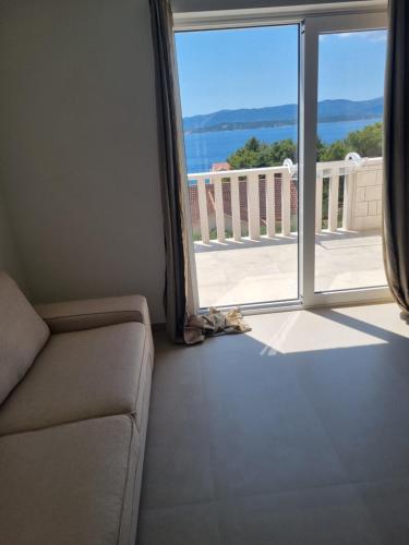 a living room with a couch and a view of a balcony at Villa Mila in Bol