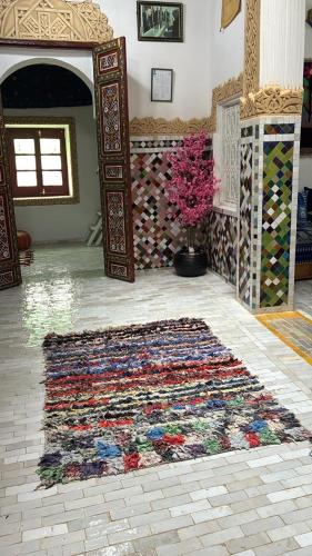 a room with a colorful rug on the floor at Riad Serendipity in Fès