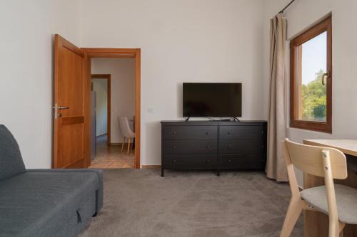 a living room with a couch and a television at MonteHygge apartments in Tivat