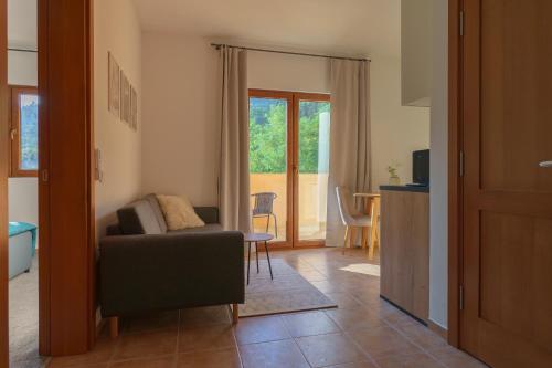 a living room with a couch and a table at MonteHygge apartments in Tivat