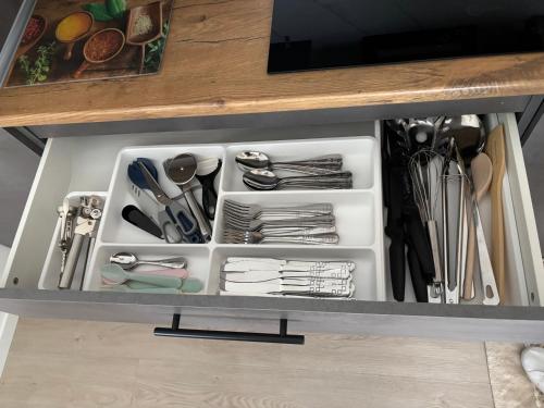 a drawer in a cabinet filled with utensils at Avens in Burgrieden
