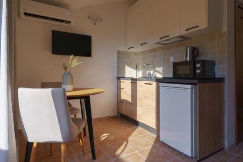a small kitchen with a table and a microwave at MonteHygge apartments in Tivat