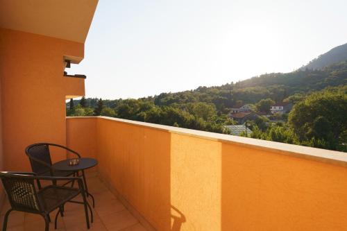 a balcony with two chairs and a table with a view at MonteHygge apartments in Tivat