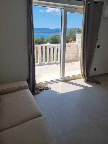 a living room with a couch and a sliding glass door at Villa Mila in Bol