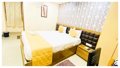 a hotel room with a bed and a table at Hotel Ru-pam Tower Patna AC or Non Ac Room in Patna