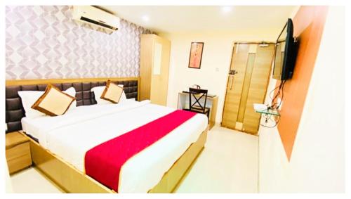 a hotel room with a bed and a television at Hotel Ru-pam Tower Patna AC or Non Ac Room in Patna