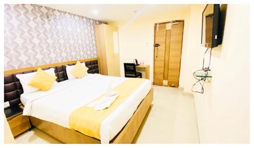 a hotel room with a bed and a television at Hotel Ru-pam Tower Patna AC or Non Ac Room in Patna