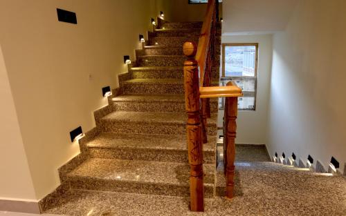 a set of stairs in a house with a stair case at Tsanavilla guest house in ladakh