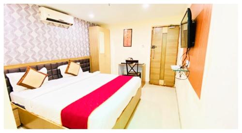 a hotel room with a bed and a television at Hotel Ru-pam Tower Patna AC or Non Ac Room in Patna
