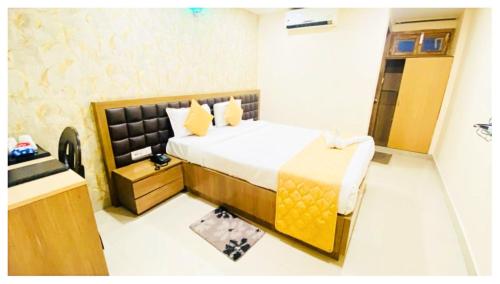 a hotel room with a bed and a sink at Hotel Ru-pam Tower Patna AC or Non Ac Room in Patna