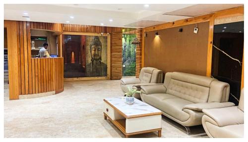 a living room with a couch and a table at Hotel Ru-pam Tower Patna AC or Non Ac Room in Patna